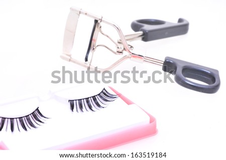 False eyelashes and eyelash curler  on a white background