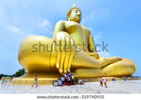 ANGTHONG, THAILAND - September 20: Unidentified people go to pray at big statue of buddha at Wat muang on Sep 20, 2015 in Angthong. It is a sitting buddha statue largest in Thailand