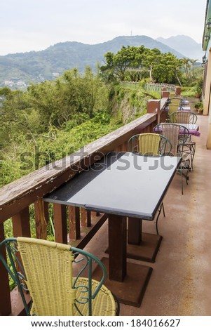 wooden chair and table outside with mountain view
