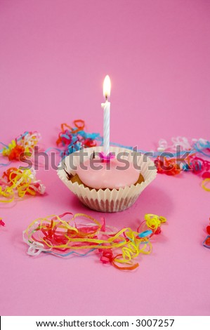 Fairy cake with one candle on pink background