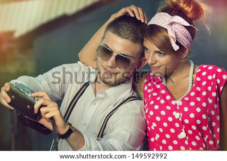 Young couple in love making self-portrait. Retro style.