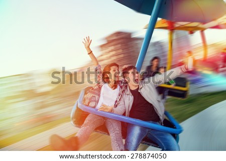 Beautiful, young couple having fun at an amusement park 商業照片 © 