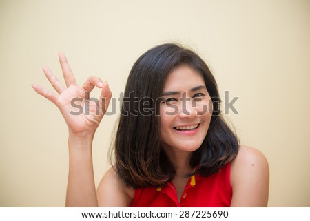asian girl show her hand say OK, good