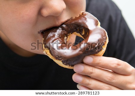 asian guy eat chocolate dough nut, dessert