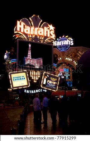 LAS VEGAS - MARCH 20: Harrah`s neon sign and Las Vegas nightlife  on March 20,2011. Opened in 1973 as the Holiday Casino, the property was renamed  Harrah\'s in 1992.