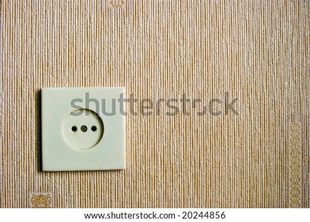 Electric wall plug at a textured wall
