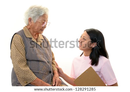 Friendly nurse cares for an elderly woman