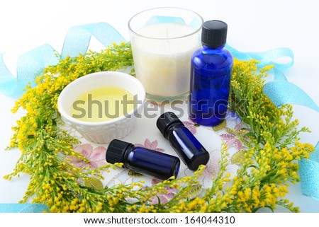 Bottles of essential oils with floral garland