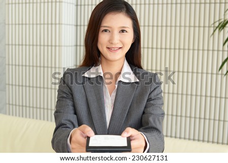 Smiling woman with business card