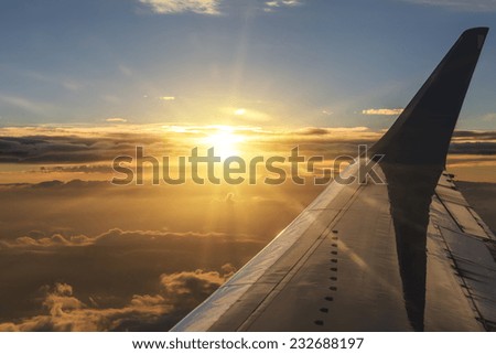 View of the clouds and airplane wing from the Inside