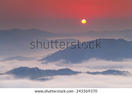 Amazing dawn sky over the misty mountains