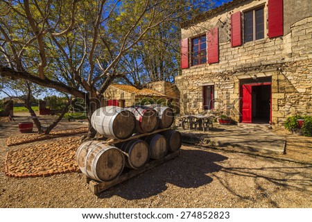 Wine barrels in the background of an ancient house. France. Languedoc, Camargue.