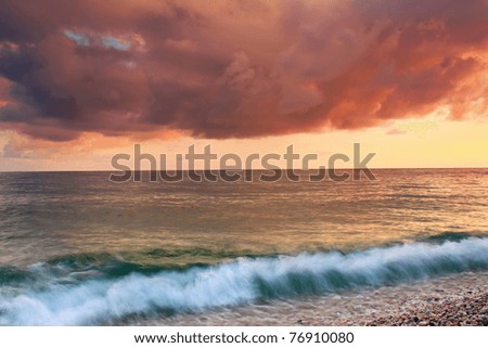 Stormy sunset at sea shore