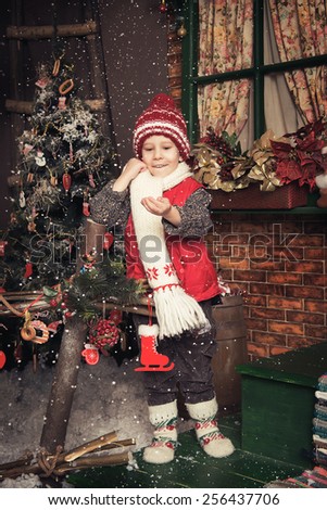 Photo of young boy playing in a Christmas garden