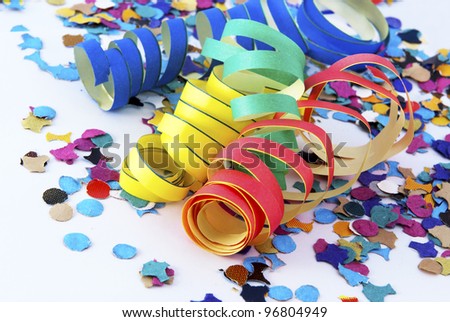 Colorful confetti and party streamer over white background