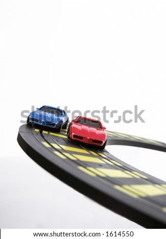 Slot cars racing on curve.