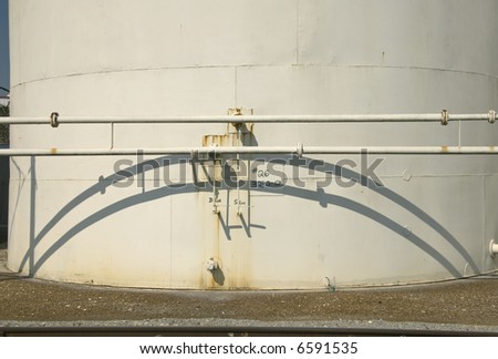 Detail of White Storage Tank with Pipes and Shadows