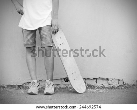 Boy with skateboard vintage retro style black and white photo