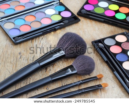 Makeup brushes make-up eye shadows vintage wooden background