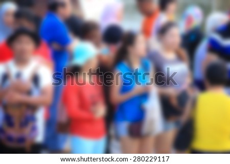 blur of unrecognized crowd people in urban background