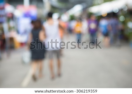blurred background of people walking shopping in agricultural fair