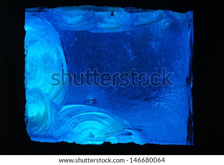 Blue background: closeup detail of abstract design in chipped slab glass in a stained glass window