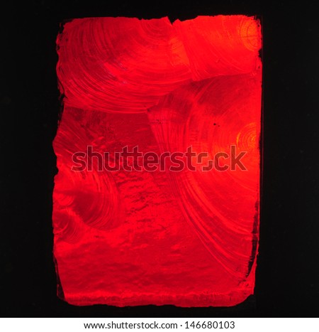 Red background: brilliant red chipped slab glass in a stained glass window in a church