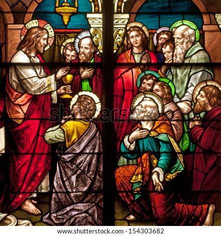 Stained glass window depicting Bible story of Last Supper with Jesus instituting the Holy Eucharist