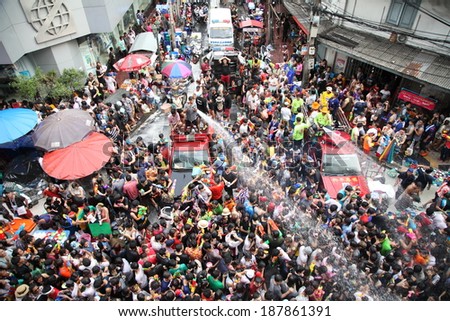 BANGKOK - APRIL 13: Stream of water over the crowd of people during celebrating the traditional Songkran New Year Festival, April 13, 2014, Silom road, Bangkok, Thailand.