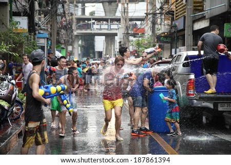 BANGKOK - APRIL 13: Stream of water over the crowd of people during celebrating the traditional Songkran New Year Festival, April 13, 2012, Silom road, Bangkok, Thailand.