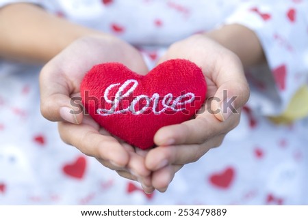 Gir holding red heart pillow in hands,Red heart.
