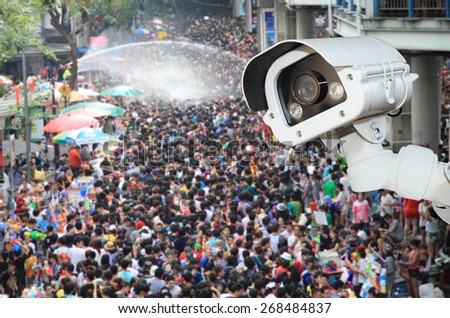 CCTV Camera Operating outside a people on songkran festival.Security camera detecting the movement of traffic.
