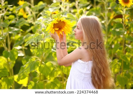 portrait of little girl with a sunflower