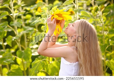 portrait of little girl with a sunflower