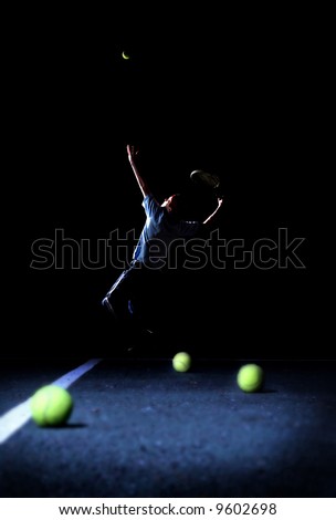Poise and Focus- A Teenager Practicing His Tennis Serve