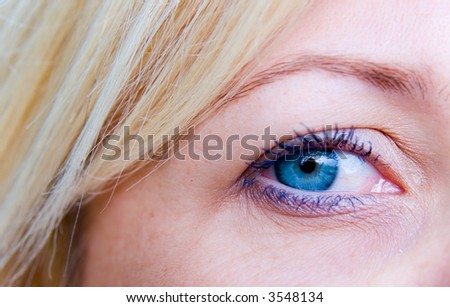 Beautiful blond woman`s open blue eye