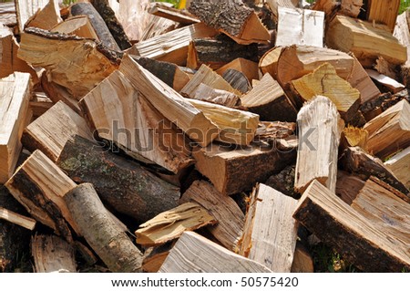 Large pile of logs, to be used as firewood.