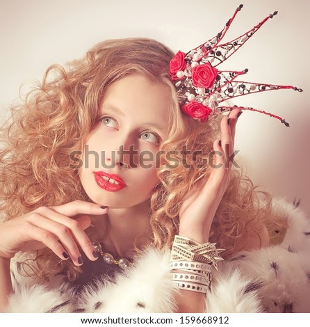 Young fashionable queen with crown and mantle