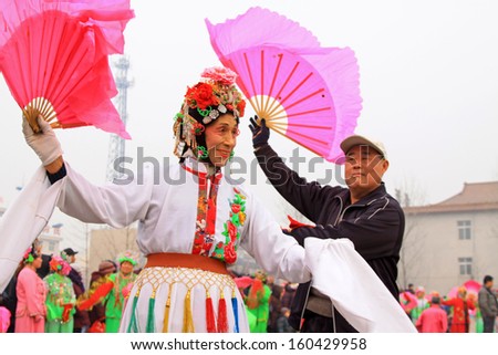 LUANNAN COUNTY, CHINA, January 31: people wearing colorful clothing, with various props, performing in the streets in Yangko dance on January 31, 2012, Luannan County, Hebei Province, China.