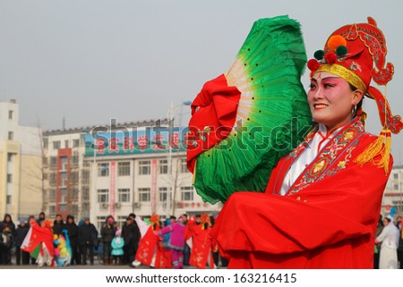 LUANNAN COUNTY - FEBRUARY 3: People wearing colorful clothing, with various props, performing in the streets in yangko dance, on february 3, 2012, Luannan County, Hebei Province, china.