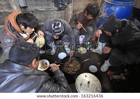LUANNAN COUNTY - APRIL 1: Workers were having lunch in the cabin of fishing boat in the ZuiDong fishing Wharf on April 1, 2012, Luannan County, Hebei Province, China.