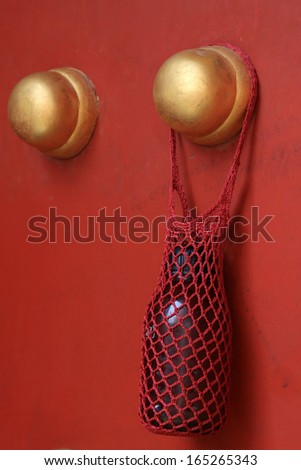 string bag and bottle hang at the door, beijing, china