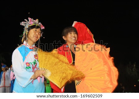 LUANNAN, CHINA, OCT 11, 2012: Women wearing colorful clothes, performing yangko dance in the streets at night, in October 11, 2012, Yellow River Village, Luannan County, china.
