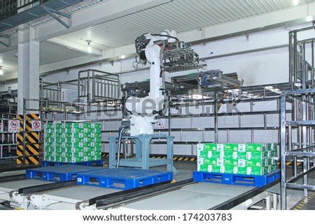 LUANNAN COUNTY, CHINA - MAY 15: Mechanical arm operation site in Mengniu Dairy Company production line packaging workshop, Luannan County, Hebei Province, China