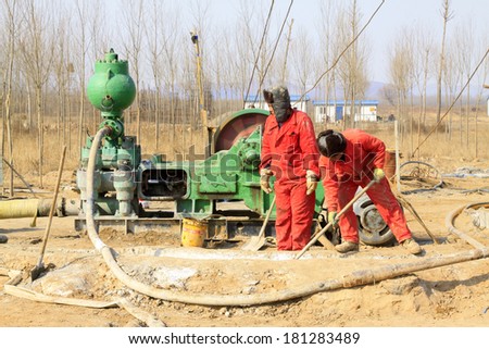 LUAN COUNTY - MARCH 9: Drilling workers weare cleaning the construction site on march 9, 2014, Luan county, hebei province, China.