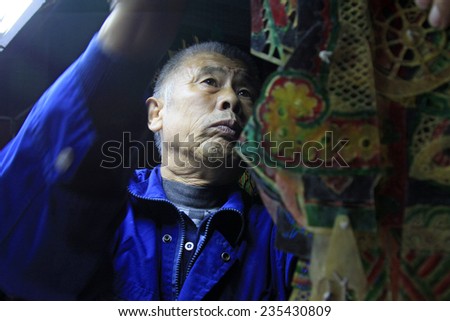 LUANNAN COUNTY- OCTOBER 2: Shadow puppet artists arranging props, on october 2, 2014, Luannan, Hebei Province, china.