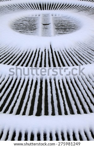Fountain metal shield in the snow, closeup of photo