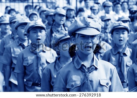 LUANNAN COUNTY - JULY 16: The Elementary student dressed in blue military uniform, solemnly swear, on July 16, 2012, luannan county, Hebei province, China