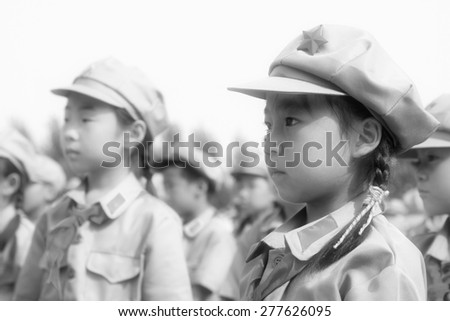LUANNAN COUNTY - JULY 16: Elementary student dressed in blue military uniform, solemnly swear, on July 16, 2012, luannan county, Hebei province, China