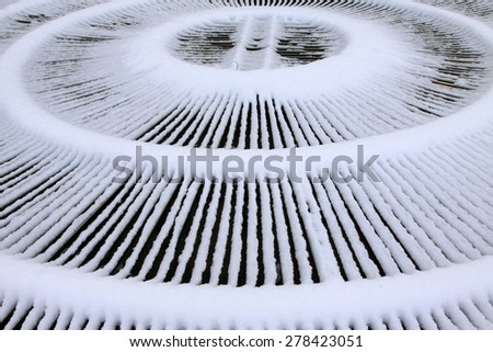 Fountain metal shield in the snow, closeup of photo